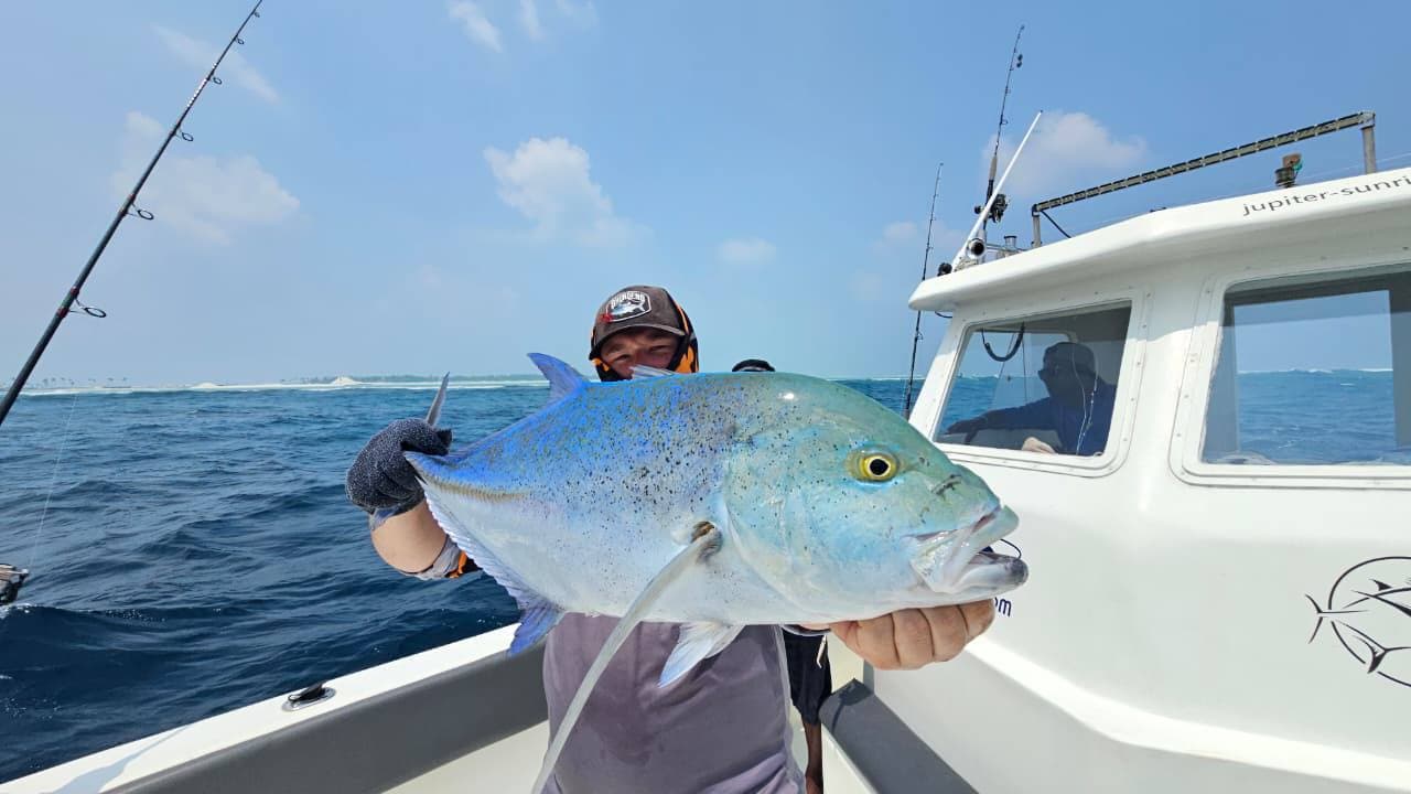 Angler holding a fish on a charter boat